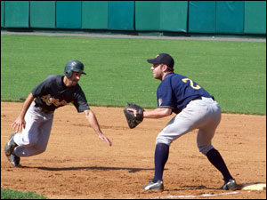 Alan Donaruma dives back to first base