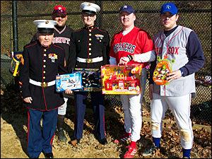 Toys for Tots representatives from the U.S. Marines, Jack McDonald and Paul Nolan, pose with Brian Bennett ad John Breslin