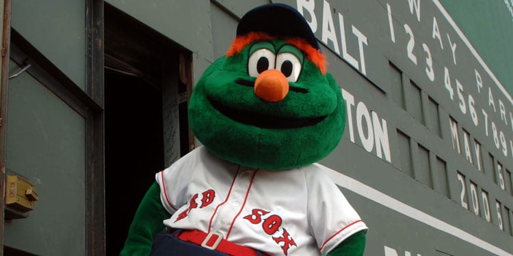 Wally the Green Monster in front of the Green Monster Wall at Fenway Park